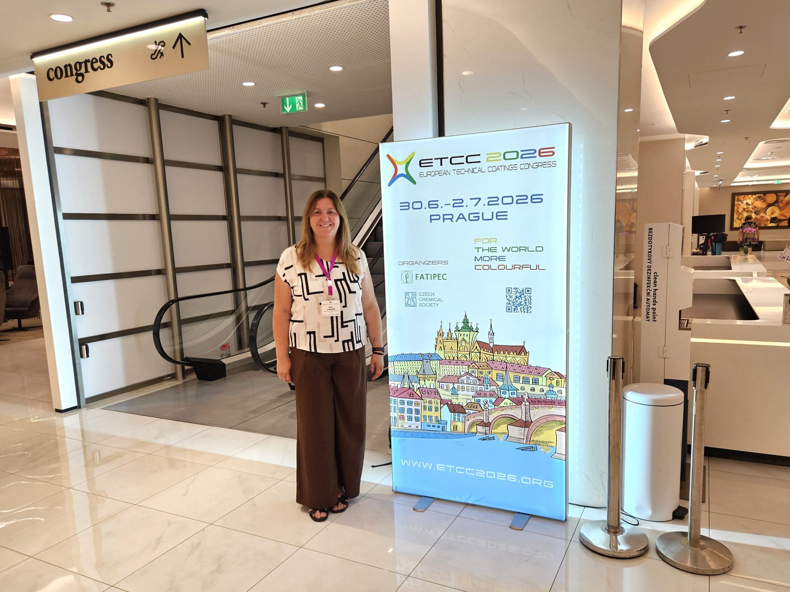 Przedstawicielka projektu RASCOS podczas European Technical Coatings Congress (ETCC) 2026 w Pradze, przy oficjalnym banerze konferencyjnym.
